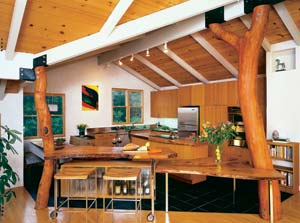 With soaring oak columns made from fallen trees and original gray-green beams, the dining room evokes the feel of being in a forest.
